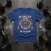 Go Grizzly Or Go Home t-shirt design featuring a roaring bear lifting a barbell, surrounded by laurel wreaths