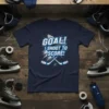 GOAL! I SHOOT TO SCORE! text with hockey puck and crossed sticks graphic on navy t-shirt