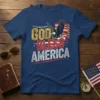 God Bless America text with an eagle and American flag graphic on a navy blue t-shirt
