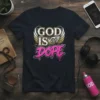 Black t-shirt with bold white and gold text reading "GOD IS DOPE" and stylized wings graphic