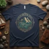 God Is Greater Than The Highs And Lows t-shirt with mountain and wave graphic, featuring gold and teal colors
