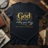 T-shirt with gold and white text "God is still writing your story. Stop trying to steal the pen" on a