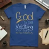 God Is Still Writing Your Story Stop Trying To Steal The Pen quote on a blue t-shirt with feather graphic
