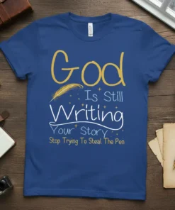God Is Still Writing Your Story Stop Trying To Steal The Pen quote on a blue t-shirt with feather graphic