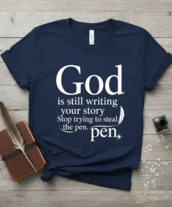 Navy blue t-shirt with white text: God is still writing your story Stop trying to steal the pen. Inspirational Christian