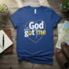 Blue t-shirt with "God No Worries Got Me" text inside a gold heart outline and cross graphic