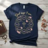 Navy t-shirt with gold text "God Says I Am" and a circular design of affirmations: Strong, Accepted, Bold, Loyal, Kind