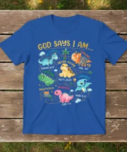 Christian t-shirt design featuring "God Says I Am" with various cute dinosaurs representing biblical affirmations like Victorious, Chosen, and Worthy