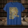 God Sees What They Do To Us quote in bold gold font on a blue t-shirt, featuring intricate graphic details