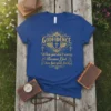 Blue t-shirt with gold text: GODFIDENCE When you don't worry Because God has your back, featuring wings and crosses graphic