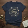Navy t-shirt with "God's grace is enough 2 Corinthians 12:9" quote inside a floral wreath design