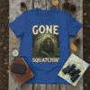 Graphic t-shirt with the text "GONE SQUATCHIN'" and a Bigfoot illustration in a forest setting