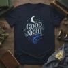 Good Night text with crescent moon and starry night graphic on a navy t-shirt