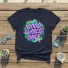 Good Vibes Only text with tropical leaves and waves graphic on a navy t-shirt