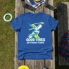 Blue t-shirt with "Good Vibes And Frisbee Flights" text and dynamic graphic of a person playing frisbee