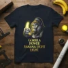 Gorilla holding a glowing banana with text "Gorilla Power Banana Light Light" on a navy t-shirt