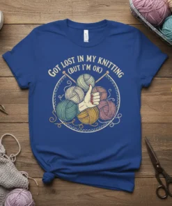 Got Lost In My Knitting (But I'm OK) text with yarn balls graphic and knitting needles on a blue t-shirt