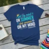 Navy t-shirt with "Got my mind ON SUMMER and summer ON MY MIND #teacherlife" text, sun, waves, palm trees, and