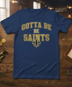 Gotta Be Saints text with a fleur-de-lis logo on a navy blue t-shirt, perfect for football fans