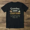 Black t-shirt with "Grandma KNOWS EVERYTHING If She Doesn't Know, She Makes Stuff Up Really Fast" text in decorative fonts