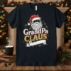 GrandPa CLAUS Christmas T-Shirt featuring a Santa graphic with festive lights and snowflakes