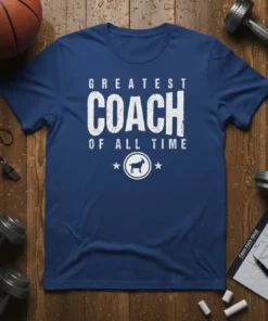 Greatest Coach Of All Time text design with a goat graphic on a blue t-shirt