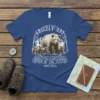 Grizzly 399 and cubs t-shirt design, featuring text "Grizzly 399 Queen of the Tetons 1996-2024" and mountain scenery