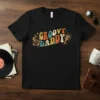 Groovy Daddy text design with retro record player and microphone graphics on a black t-shirt