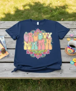 Groovy Mama text in a colorful retro font with floral mandala design on a navy t-shirt