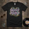 Groovy Mama text with colorful retro flowers and swirling lines on a black t-shirt