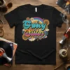 Groovy Sister text in a retro 70s font with a rainbow and flowers design on a black t-shirt