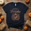 Navy blue t-shirt with "Growing A Little Pumpkin" text and a decorative pumpkin graphic featuring baby footprints