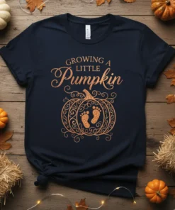 Navy blue t-shirt with "Growing A Little Pumpkin" text and a decorative pumpkin graphic featuring baby footprints