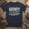 Grumpy Just Like Grampy Only Grumpier text design on a navy blue t-shirt, vintage distressed font