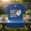 Guess What? Chicken Butt! text with a cartoon rooster graphic on a navy blue t-shirt