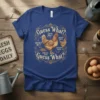 Blue t-shirt with "Guess What? Guess Why? Chicken Butt, Chicken Thigh, Chicken Pooi, Guess What?" design featuring chickens and humor