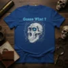 Guess What ? text above a detailed skull graphic with glowing blue eyes on a royal blue t-shirt