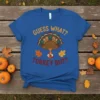 Guess What Turkey Butt funny Thanksgiving t-shirt with a cartoon turkey upside down and autumn leaves