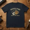 GUITAR & PAWS MUSIC & LOVE FOR ALL text with guitar and paw print graphic on a navy t-shirt