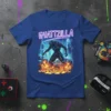 Gyattzilla neon text above a fire-breathing cyborg monster in a futuristic city, featured on a blue t-shirt