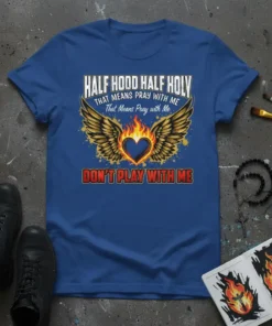 Blue t-shirt with "Half Hood Half Holy That Means Pray With Me Don't Play With Me" text, wings, and flaming
