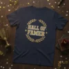 Navy blue t-shirt with "Hall of Famer" text in gold lettering, surrounded by a gold laurel wreath and stars