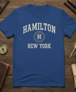 Hamilton New York text design on a royal blue t-shirt with a shield logo and 'H'