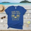 Hapa Wife Hapa Life text with palm trees and hammock design on a blue t-shirt