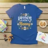 Happiness Is Being A Nanny quote on a blue v-neck t-shirt, surrounded by a floral wreath design