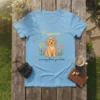 Light blue t-shirt with "Happiness is everywhere you look" quote and a cute golden retriever puppy wearing a flower crown
