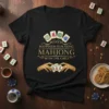 T-shirt with the quote "Happiness Is Playing Mahjong With The Girls" in elegant gold font, featuring mahjong tiles and hands