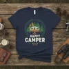 Happy Camper t-shirt design featuring a vintage camper, campfire, trees, and axes, with "Happy Camper" text
