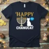 Happy Chanucat Meowzel Toy T-Shirt with a white cat and a menorah design