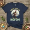 Happy Easter Bigfoot t-shirt design with Bigfoot wearing bunny ears and holding an Easter egg, set against a moonlit forest